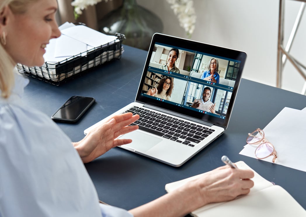 Woman Taking Down Notes While on a Video Call 